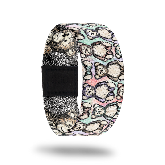 Outside design of Hug It Out. Drawn teddy bear pattern over a blended background of light colors of green, pink, and purple. The drawn teddy bears are also randomly light colored green, pink, purple, and yellow