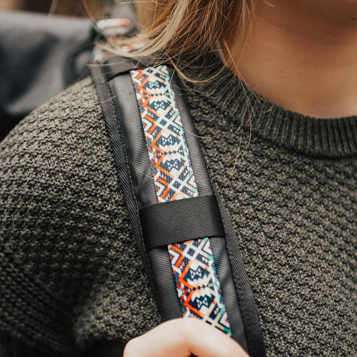 lifestyle photo of the Imperial v2 with a different colored tension strap on a woman's shoulders