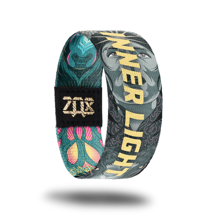 product image of a wristband named Inner Light. The backside shows the same image of a hand drawn face with a shining star on the forehead. as the front but in grey.