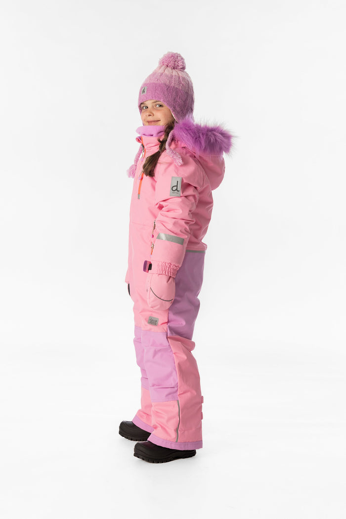 Child wearing the pink Deux par Deux PLAY one-piece snowsuit, side view