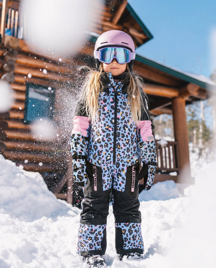Child wearing the Deux par Deux TEKNIK one-piece snowsuit in blue leopard print, view 5