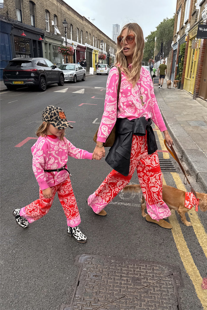 Kids Red and Pink Bandana Knitted Set on a child walking with a model and a dog on a London street.