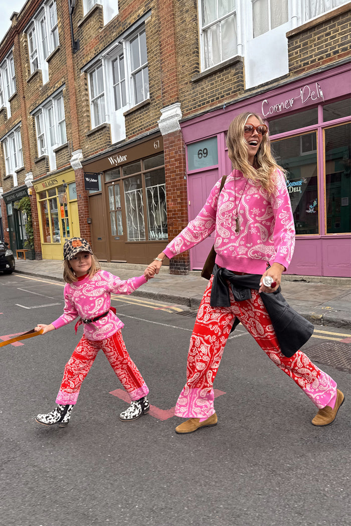 Kids Red and Pink Bandana Knitted Set worn by a child with a matching adult on a London street.