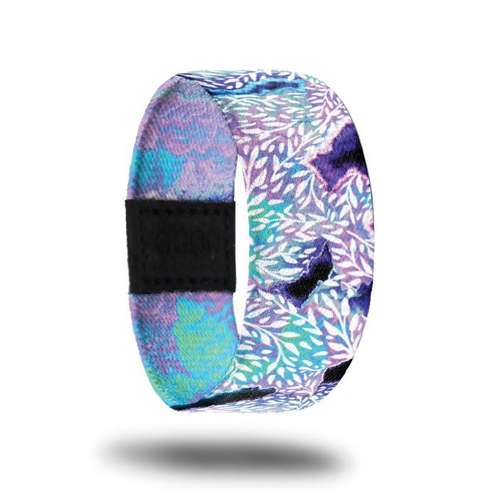Outside design for Kindness Is Contagious. A blended background of light pink and blue with a few dark purple areas and leaf patterns in white over the background