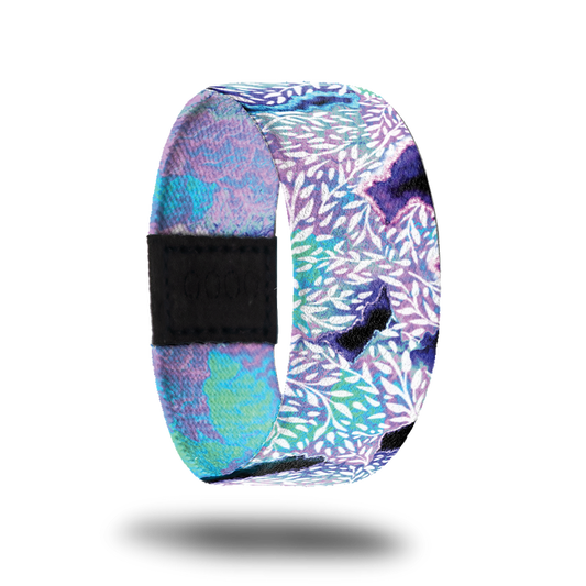 Outside design for Kindness Is Contagious. A blended background of light pink and blue with a few dark purple areas and leaf patterns in white over the background