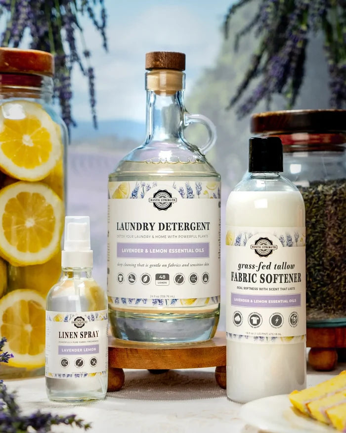 Rustic Strength - Laundry Starter Set | Lavender & Lemon (24oz Laundry Detergent, 16oz Tallow Fabric Softener & 4oz Linen Spray) with jars of lavender buds and sliced lemons