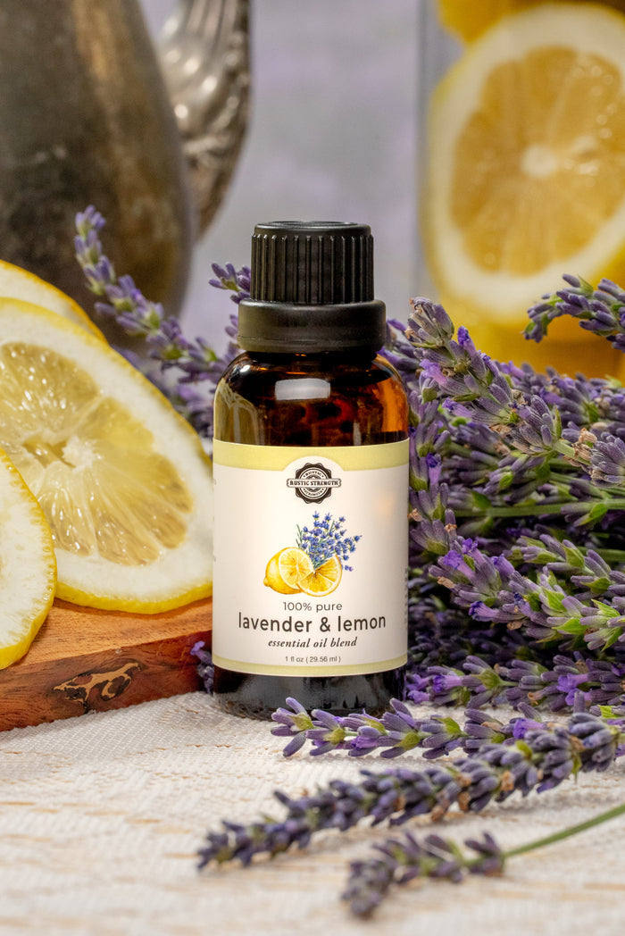 Rustic Strength - photoshoot image of Lavender & Lemon Essential Oil set with a background of lavender flowers and sliced lemons