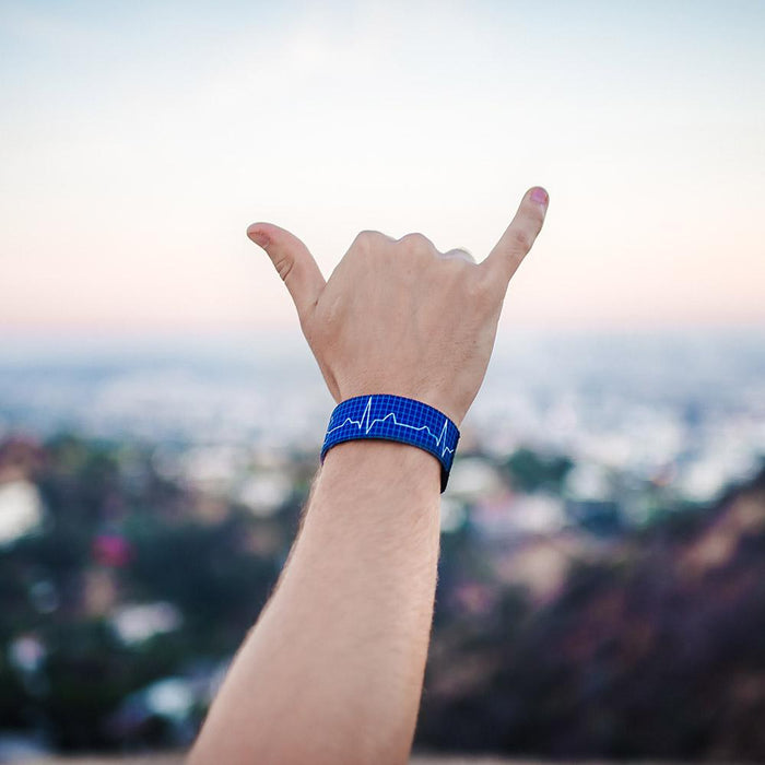 Lifestyle image of hand giving the hang loose sign with Life Saver on wrist