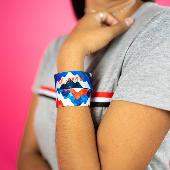 Studio image close up of 2 Live Happily on model's wrist