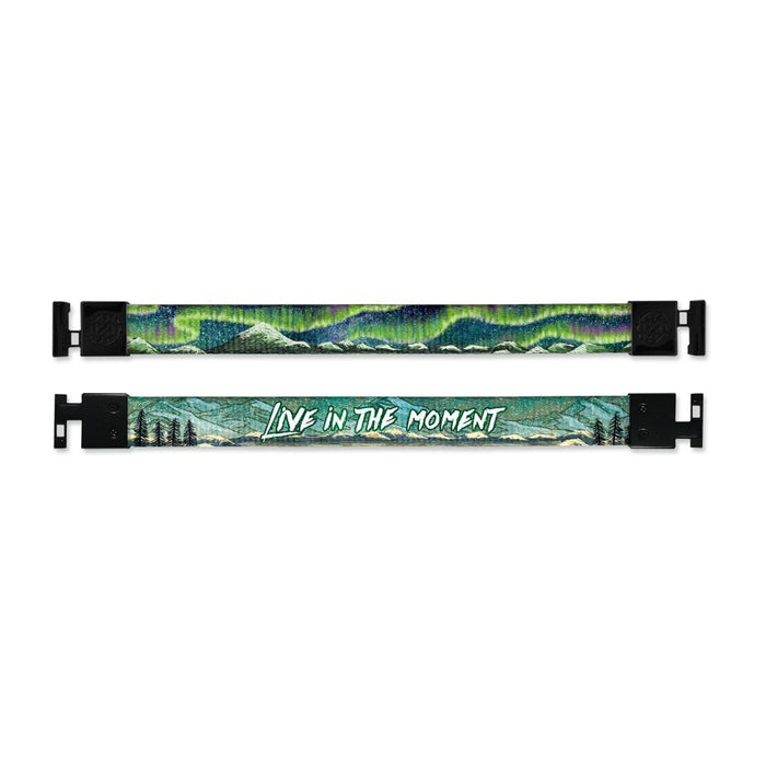 Shows outside and inside design for Live In The Moment imperial with black aglet clasps. Top is the outside design of a small mountain range and an Aurora Borealis with a green and blue tone. Bottom is the inside design with a mountain range scene with a few trees to the side and centered Live In The Moment in white text.