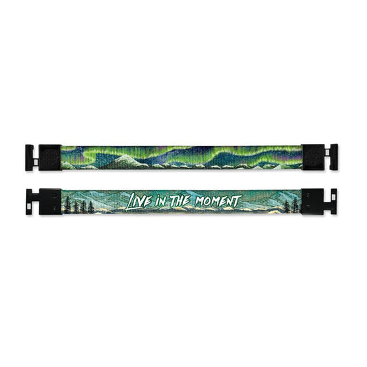 Shows outside and inside design for Live In The Moment imperial with black aglet clasps. Top is the outside design of a small mountain range and an Aurora Borealis with a green and blue tone. Bottom is the inside design with a mountain range scene with a few trees to the side and centered Live In The Moment in white text.