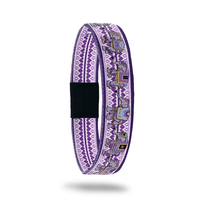 Product photo of Love Remembers showing the outside design. It is mainly purple with elephants on top of the geometric background pattern. It was created to help fight Alzheimer's