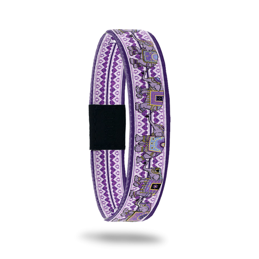 Product photo of Love Remembers showing the outside design. It is mainly purple with elephants on top of the geometric background pattern. It was created to help fight Alzheimer's