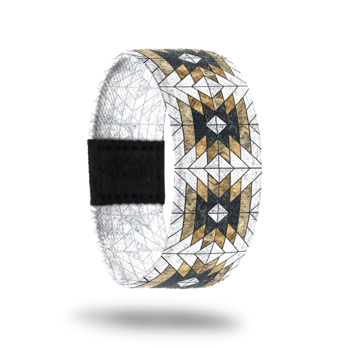 Outside design of Love Who You Are. Geometric repeating pattern with the colors white, yellow-gold, and black.