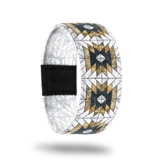 Outside design of Love Who You Are. Geometric repeating pattern with the colors white, yellow-gold, and black.