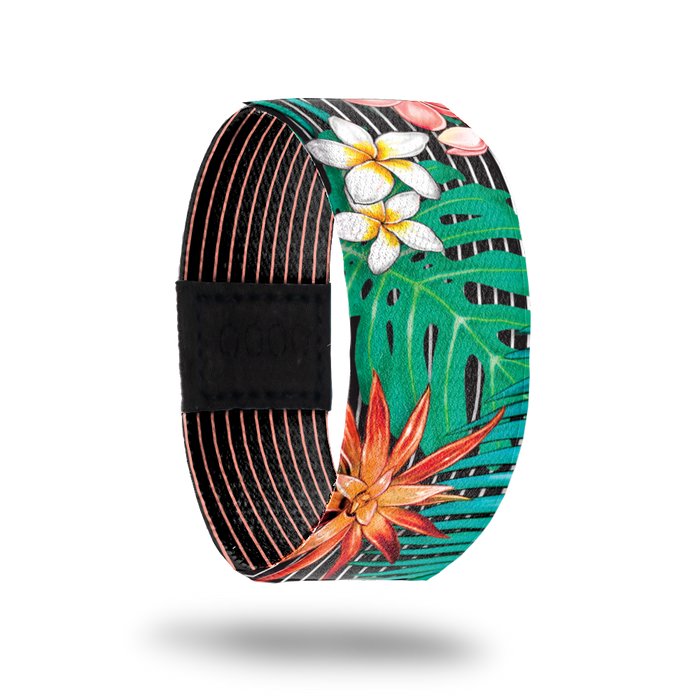 Outside design of Make It Happen. Black background with several thin white lines running along the design. Atop the background are green paint life, white and yellow flowers, and orange flowers