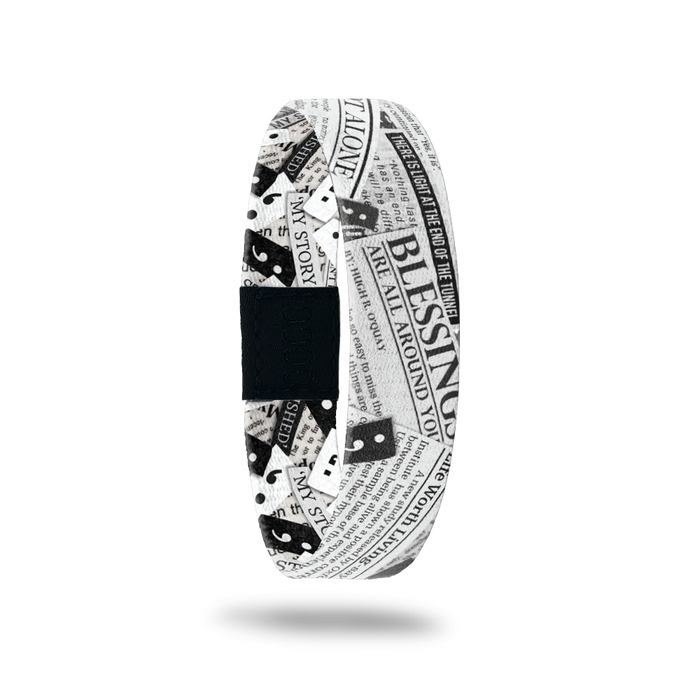 Outside design for My Story Isn't Finished: black and white design that has positive affirmation made newspaper articles overlapping each other and a few semi colon symbols spread along the design