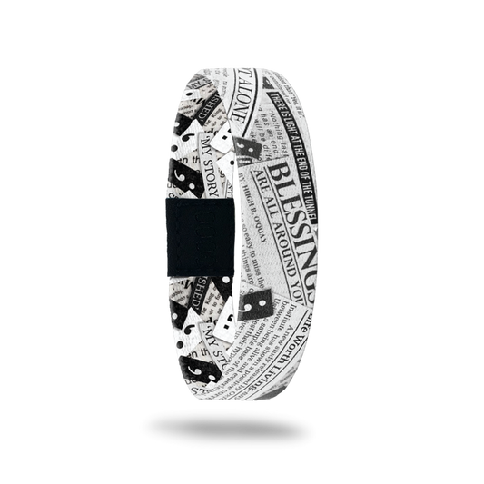Outside design for My Story Isn't Finished: black and white design that has positive affirmation made newspaper articles overlapping each other and a few semi colon symbols spread along the design