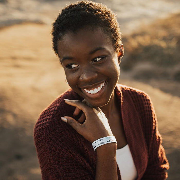 Lifestyle image of someone smiling and wearing Never Give Up
