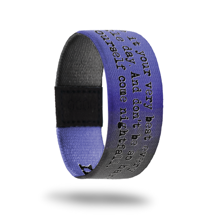 Outside design for Nightfall. A gradient background that moves across the design from light purple, dark purple, to light grey. Across the design in black text is Give it your very best every single day. And don't be so hard on yourself come nightfall. On one side is an illustrated outline of a typewriter.