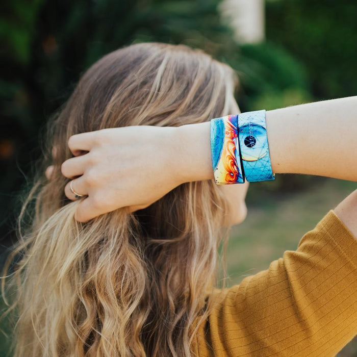 lifestyle image of a woman wearing two Not Tomorrow, Today. One showing the front and one showing the back while holding her hair