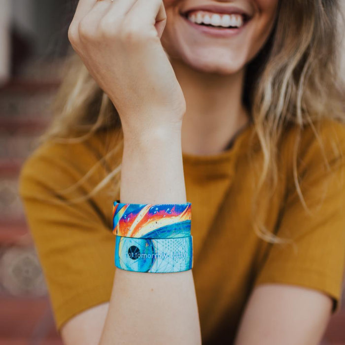 lifestyle image of a woman wearing two Not Tomorrow, Today. One showing the front and one showing the back while smiling