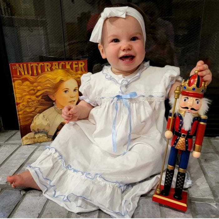 white knit nutcracker clara dress with blue ribbon,