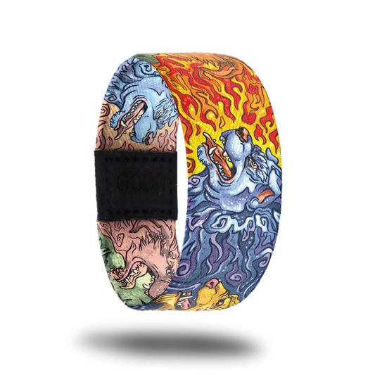 Outside design for On Guard. Three elemental guardian canine heads run along the design and positioning on each strap can vary. The three elements featured are a blue water canine, a red and yellow fire canine, and a green and yellow nature canine