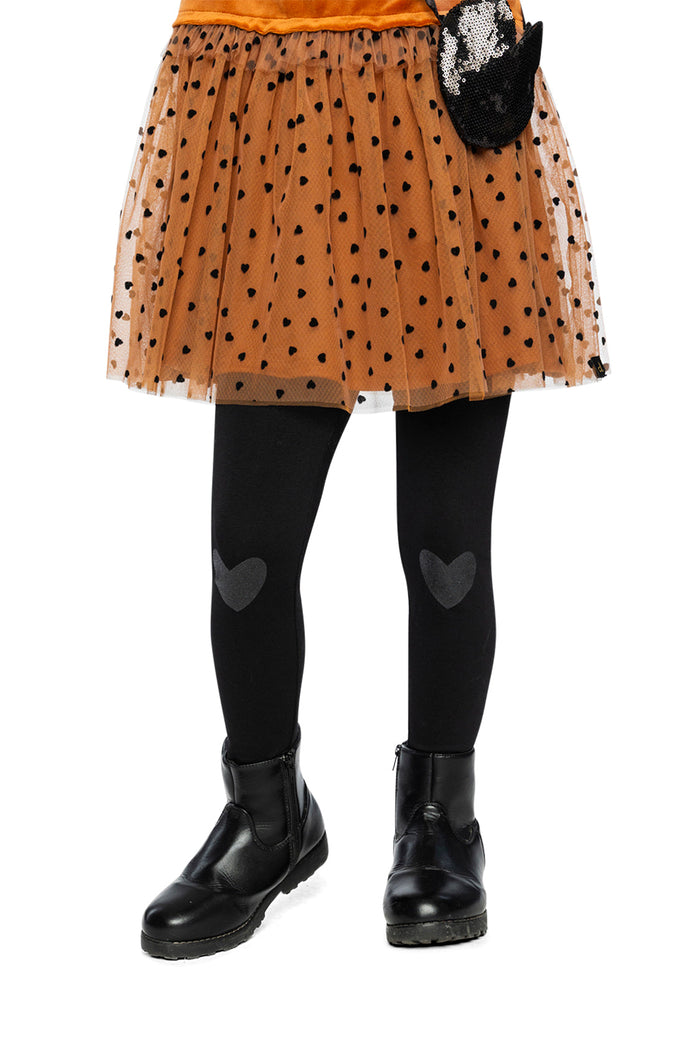 Child wearing Deux par Deux black organic cotton leggings with heart knee patches, lookbook view 1