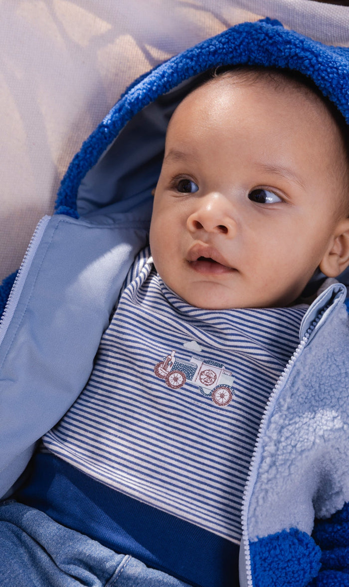 Baby wearing the Deux par Deux organic cotton onesie in blue and white stripes, view 2