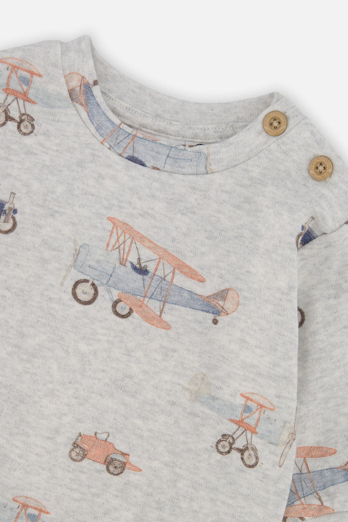Close-up detail of the Deux par Deux top and pants set in beige vintage airplane print, view 4