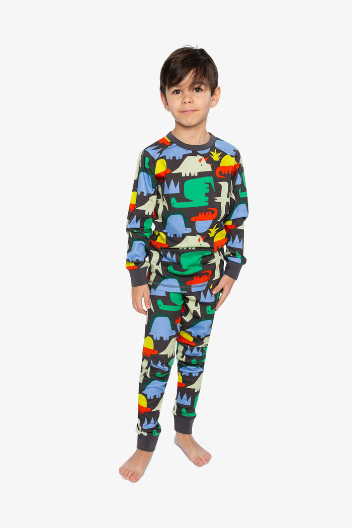 Child wearing the Deux par Deux black dinosaur print organic cotton pajama set, lookbook photo 1