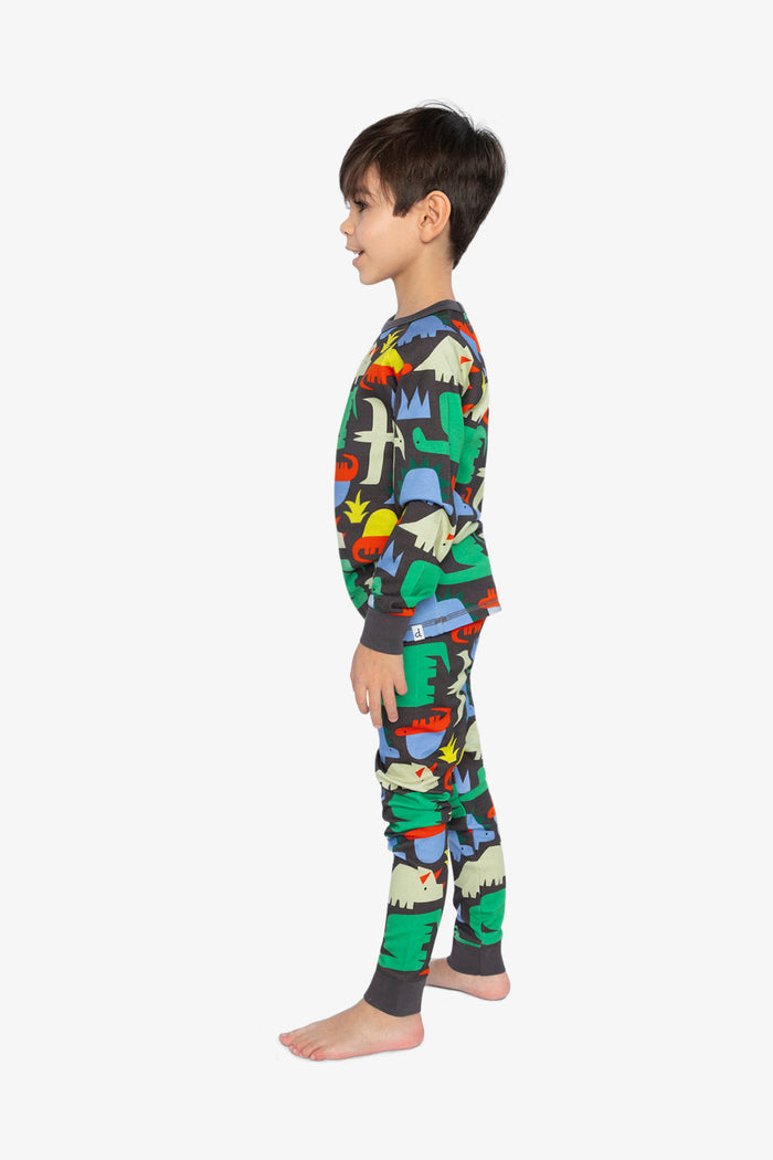 Child wearing the Deux par Deux black dinosaur print organic cotton pajama set, lookbook photo 2