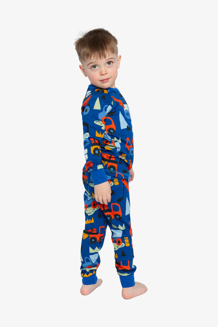 Child wearing the Deux par Deux blue truck print organic cotton pajama set, lookbook photo 3