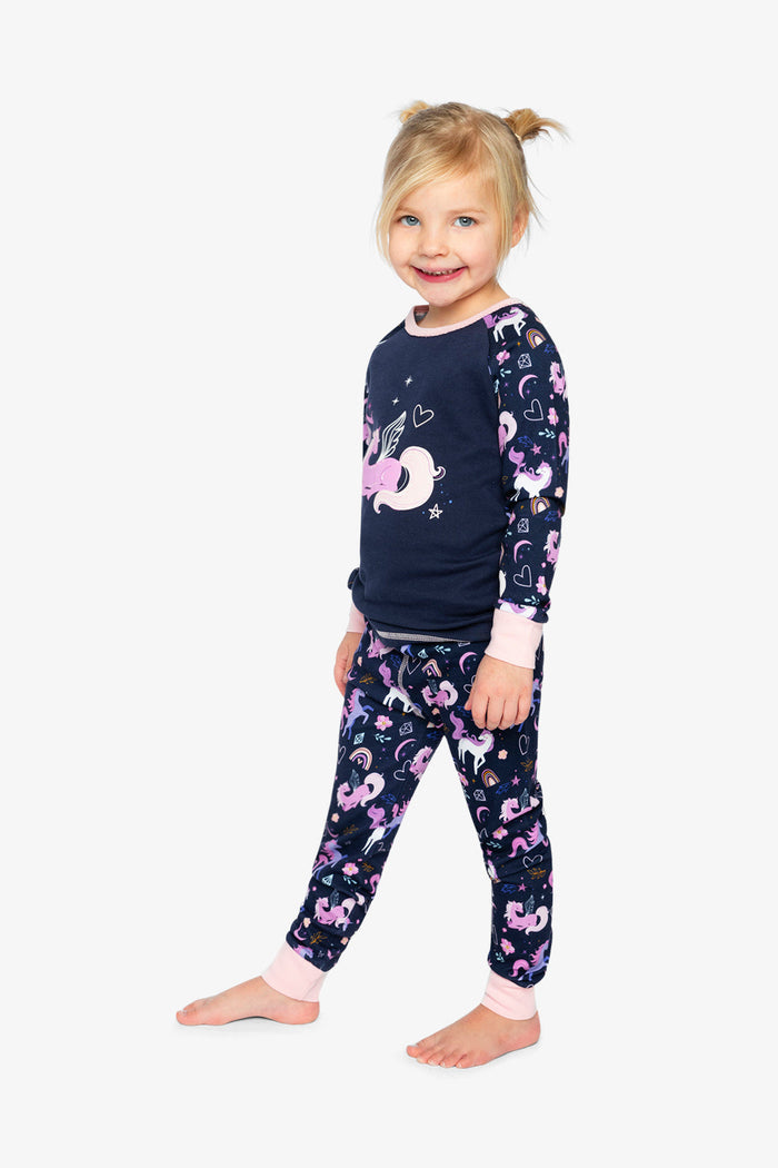 Child wearing the purple unicorn print two-piece pajama set by Deux par Deux, lookbook photo 2