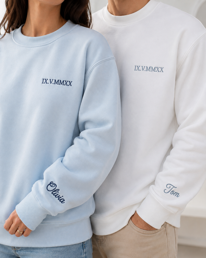 black sweatshirt with custom embroidered roman numerals and sleeve name detail