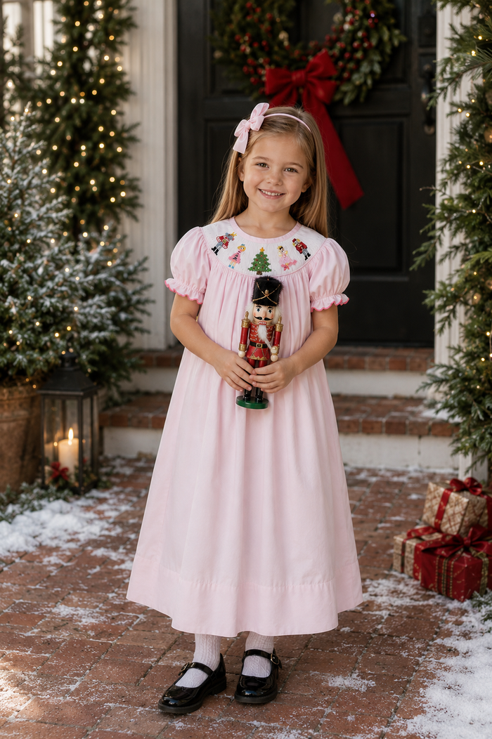 pink bishop dress with colorful nutcracker smocking for christmas