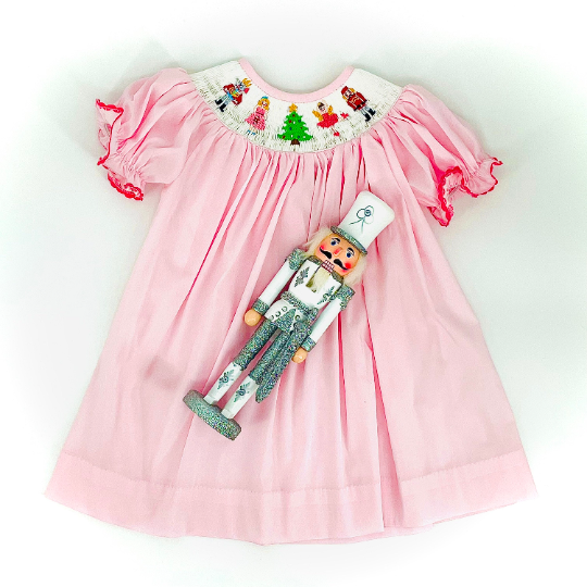 pink bishop dress with colorful nutcracker smocking for christmas
