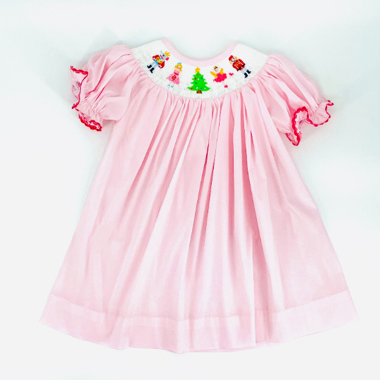 pink bishop dress with colorful nutcracker smocking for christmas