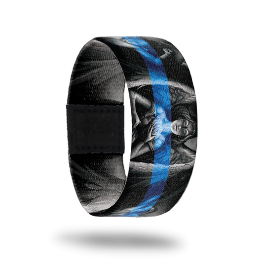 Outside design of Protector, gray scale statue of an angel in the center and two other angels next to the centered angel with a black background. With a blue transparent line centered across the design.