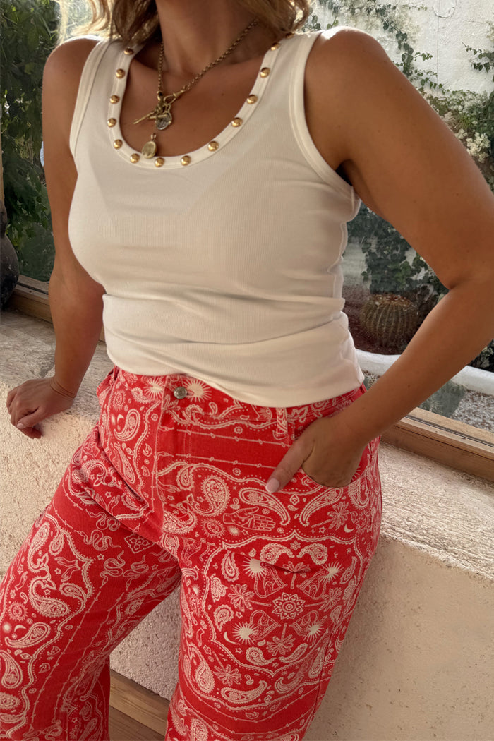 Iconic Red Bandana Jeans with a white paisley print on red denim, paired with a white gold-studded ribbed top.