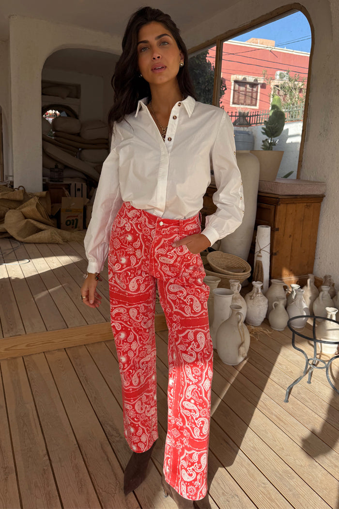 Red Bandana Jeans Petite featuring a white paisley pattern and straight-leg fit, styled with a long-sleeved white shirt.