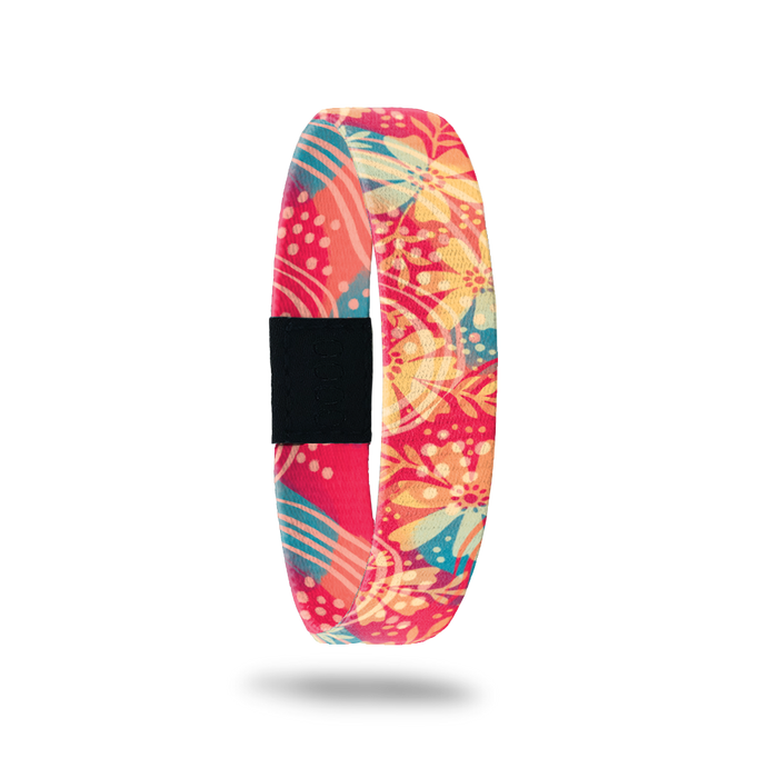 Product photo of the outside of release my past. It is a bright coral background with a yellow floral design with teal leaves.