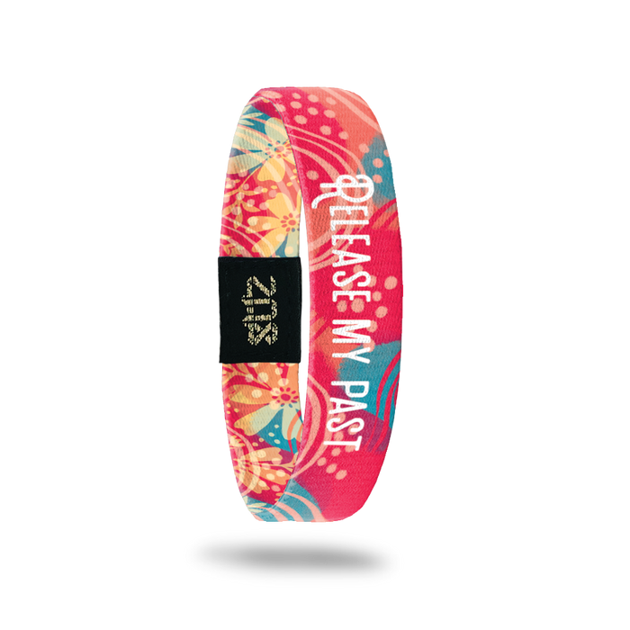 Product photo of the inside of release my past. It is a bright coral background with teal leaves with light coral lines and a white text release my past overlaying.