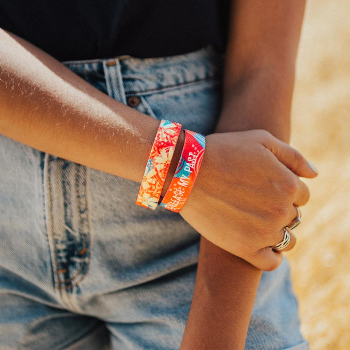 Lifestyle photo of girl holding her arm, showing release my past strap inside and outside of strap.