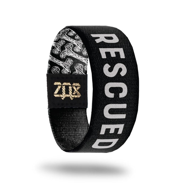 inside design for Rescued. Black background with Rescued in white text at the center