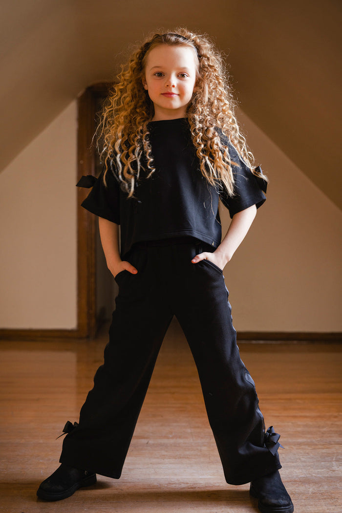 Child wearing the Deux par Deux black short sleeve milano top
