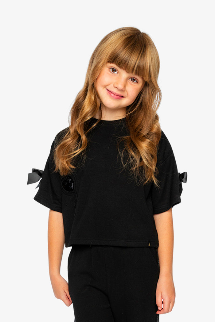 Lookbook: child wearing the Deux par Deux black short sleeve milano top
