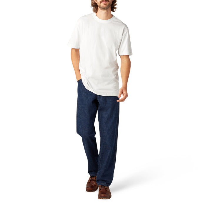 Man wearing white short sleeve crew neck t-shirt with dark blue jeans and brown shoes.