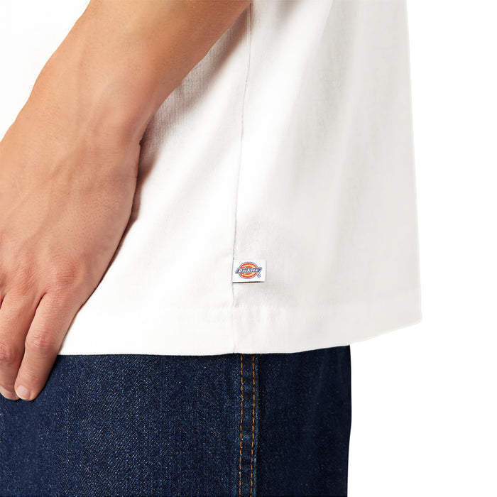 White short-sleeve t-shirt with small brand label on side seam, shown on model wearing dark denim.